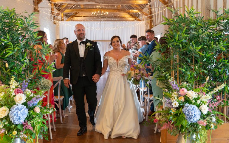 Bride walking down the aisle at The Barns at Alswick