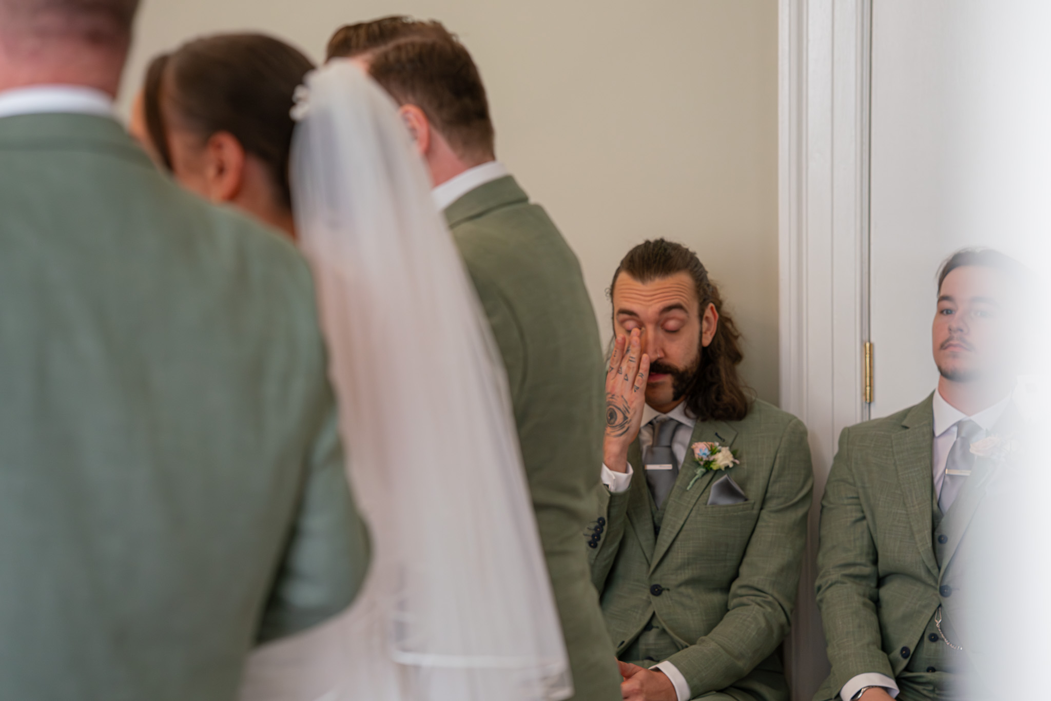 Bride and groom about to kiss under flowing veil in golden sunlight, colour wedding portrait