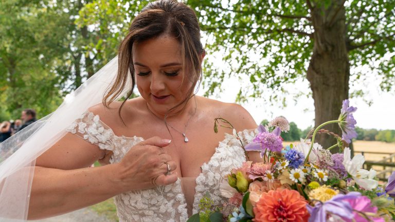 Bride laughing with her bouquet at The Barns at Alswick