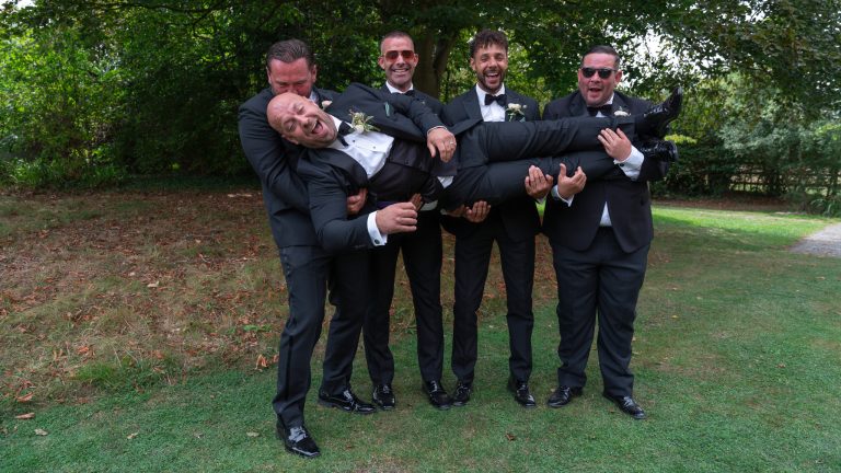 Groomsmen having fun in the grounds at The Barns at Alswick