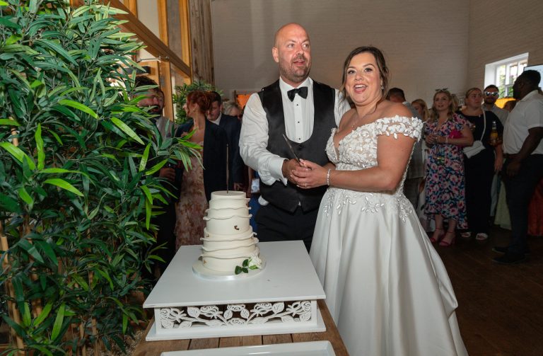 Couple cutting their cake at The Barns at Alswick