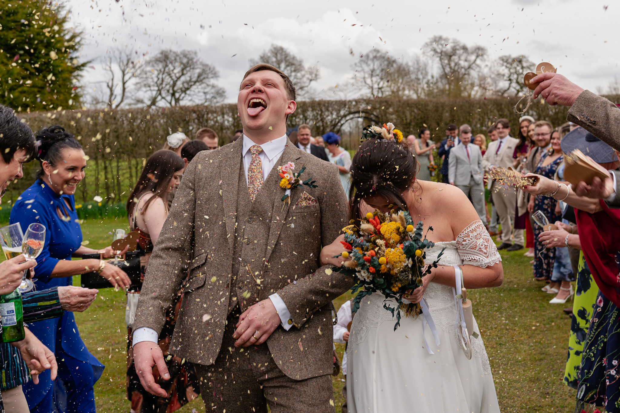 Bride and groom dancing together as guests join in on the dancefloor at a Hertfordshire barn wedding