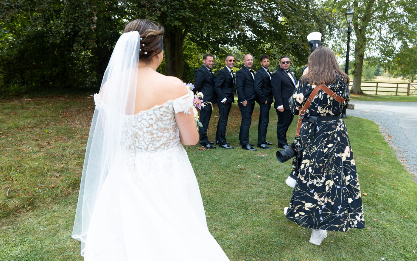 Tracy photographing groomsmen laughing at a wedding