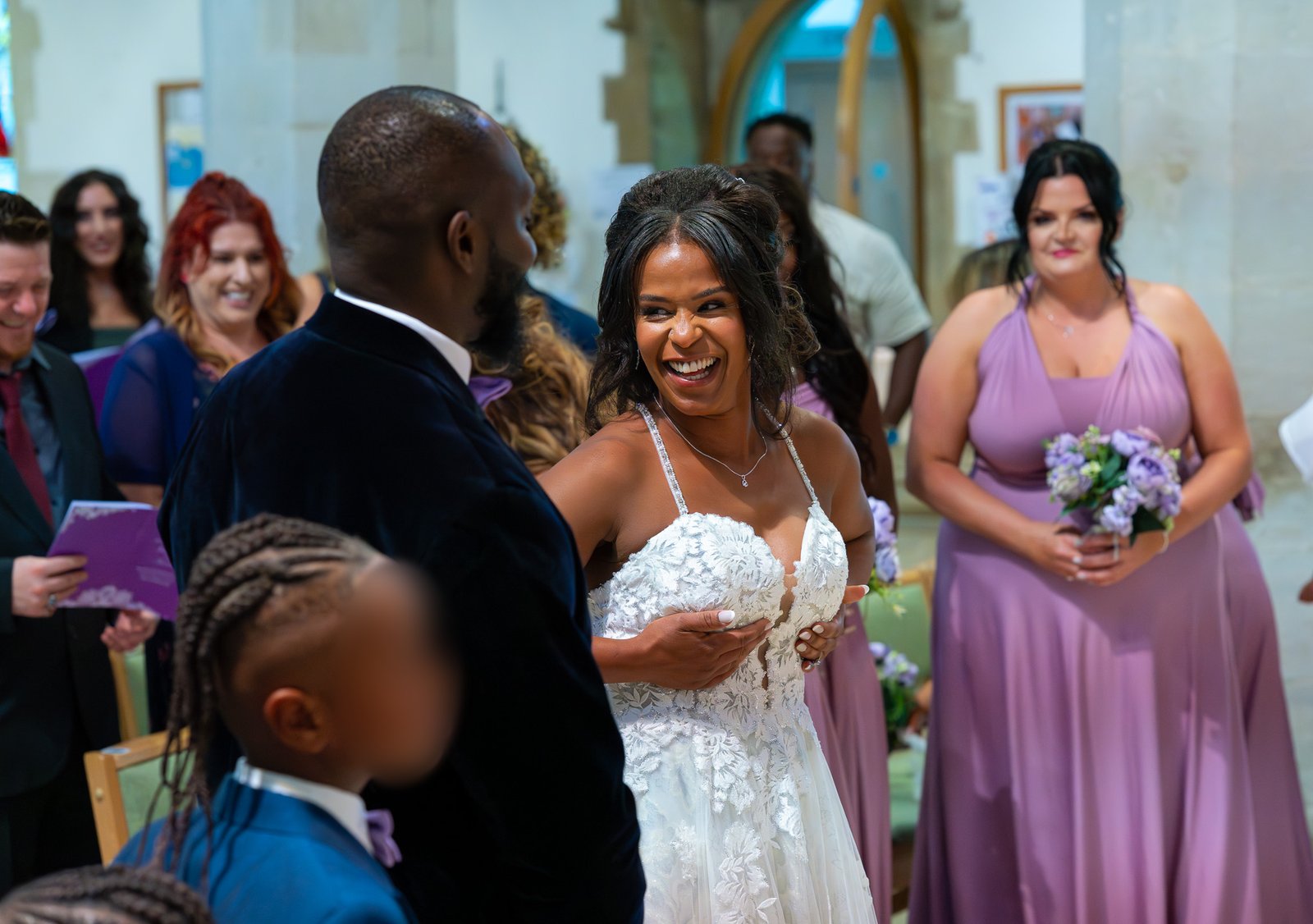Bride pulling a playful dance move on the dancefloor at her Hertfordshire wedding reception
